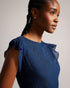LAURAE-Dresses-LAURAE is a show-stopper. The metallic fibres and ruffle details are guaranteed to turn heads, while the bow tied back make it the perfect occasion piece. Maxi dress A-line Ruffle details Metallic fibres Bow tied back V-neck Sleeveless Awuoi is 5'10.5" / 1.79m and wears Dark Blue in a Ted size 1- Ted Baker Romania
